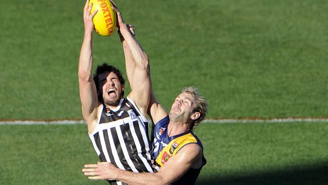  Port Adelaide Magpies and Power forward John Butcher takes a strong grab during the Foxtel Cup. 