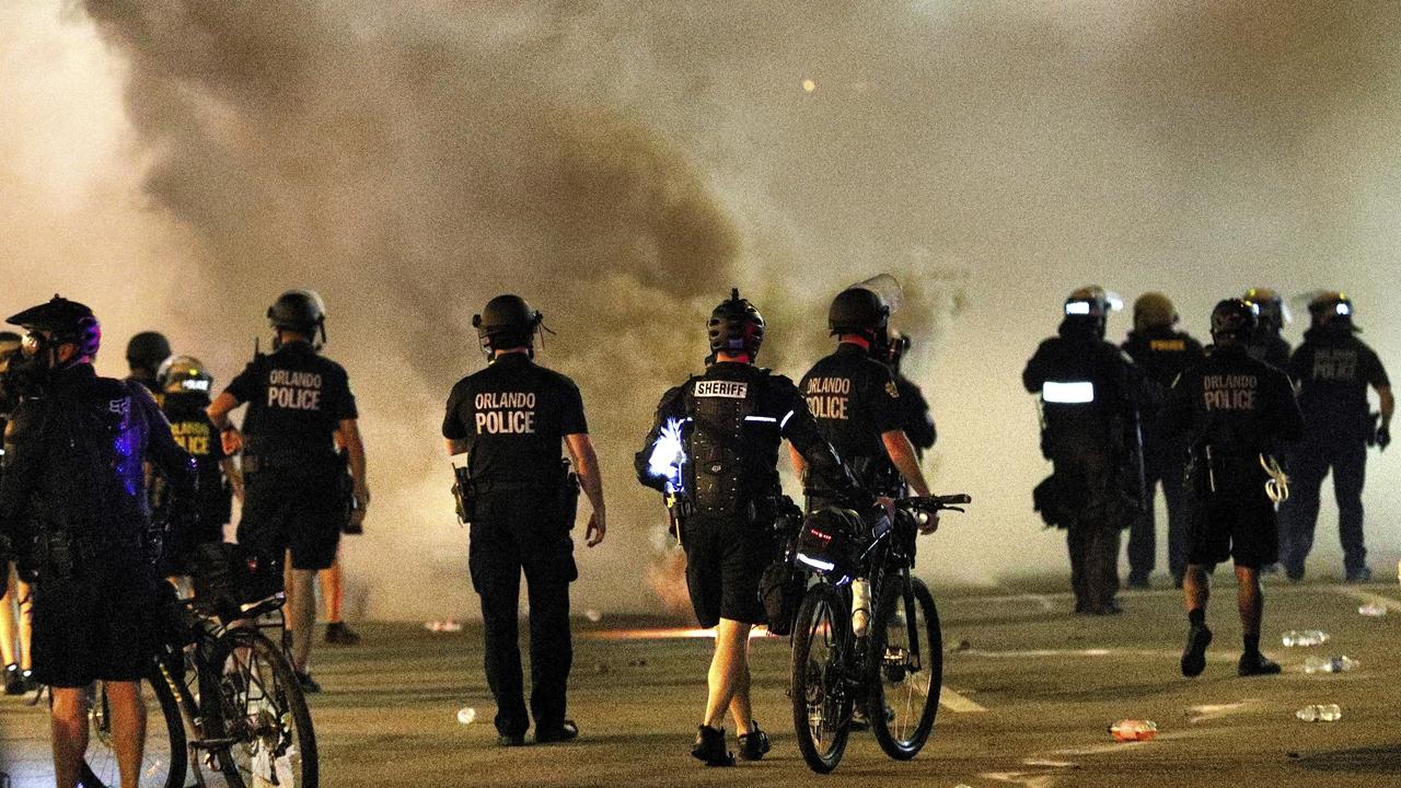 Orlando police deploy tear gas during a demonstration outside Orlando City Hall in downtown Orlando. Picture: Joe Burbank/Orlando Sentinel via AP