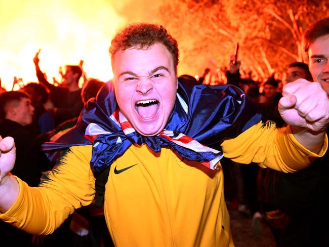 Australian fans celebrate in Melbourne on December 1, 2022, during Australia's victory over Denmark in their Qatar 2022 World Cup Group D football match. (Photo by William WEST / AFP)