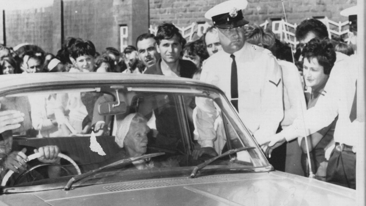 Ronald Ryan’s mother arrives at Pentridge Prison the afternoon before her son’s hanging amid a crowd of anti-execution protesters.