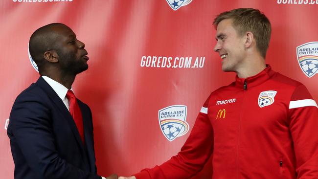 Adelaide United Director of Football Bruce Djite (left) announces the signing of Norwegian striker Kristian Opseth on July 31. Picture: AAP Image/Kelly Barnes