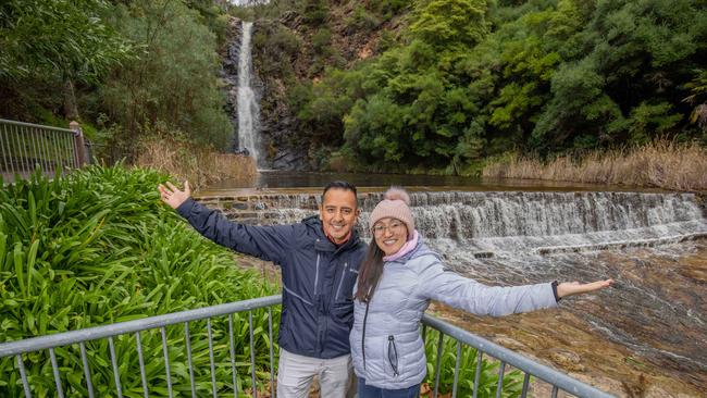 Omar Alcantara and Ana Montoya are among those flocking to see the roaring waterfall at the top of Waterfall Gully Rd. Picture: Ben Clark