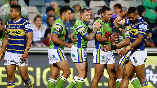 Jordan Rapana celebrates scoring a try for the Raiders as Eels players look on.