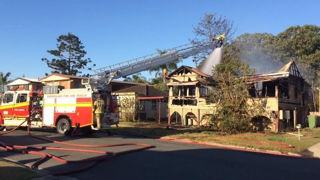 Fire crews try to extinguish a house fire on the Gold Coast