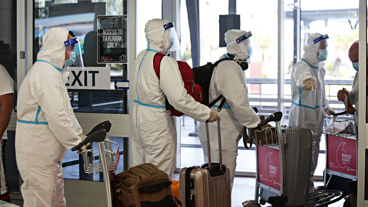 People in full PPE arriving at Sydney International Airport. Picture: Adam Yip