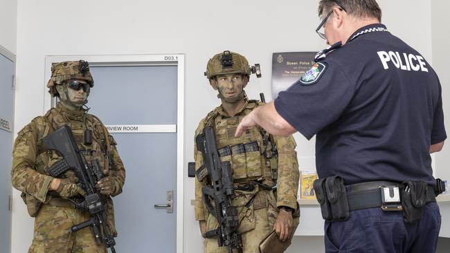 Australian Army soldier Corporal Ben Dauncey and Army officer Lieutenant William Proudford from 3rd Battalion Royal Australian Regiment Charlie Company liaise with Bowen Police Senior Sergeant Craig Shephard. Picture: Supplied