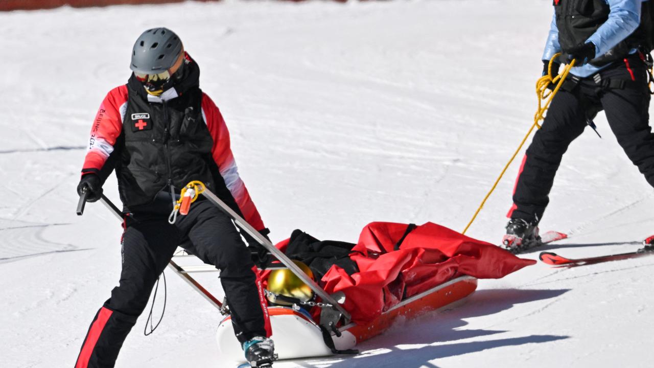 Dominik Schwaiger is taken off the course with a stretcher