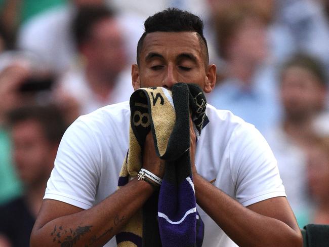 Australia's Nick Kyrgios reacts as he plays Japan's Kei Nishikori in their men's singles third round match on the sixth day of the 2018 Wimbledon Championships at The All England Lawn Tennis Club in Wimbledon, southwest London, on July 7, 2018. / AFP PHOTO / Oli SCARFF / RESTRICTED TO EDITORIAL USE