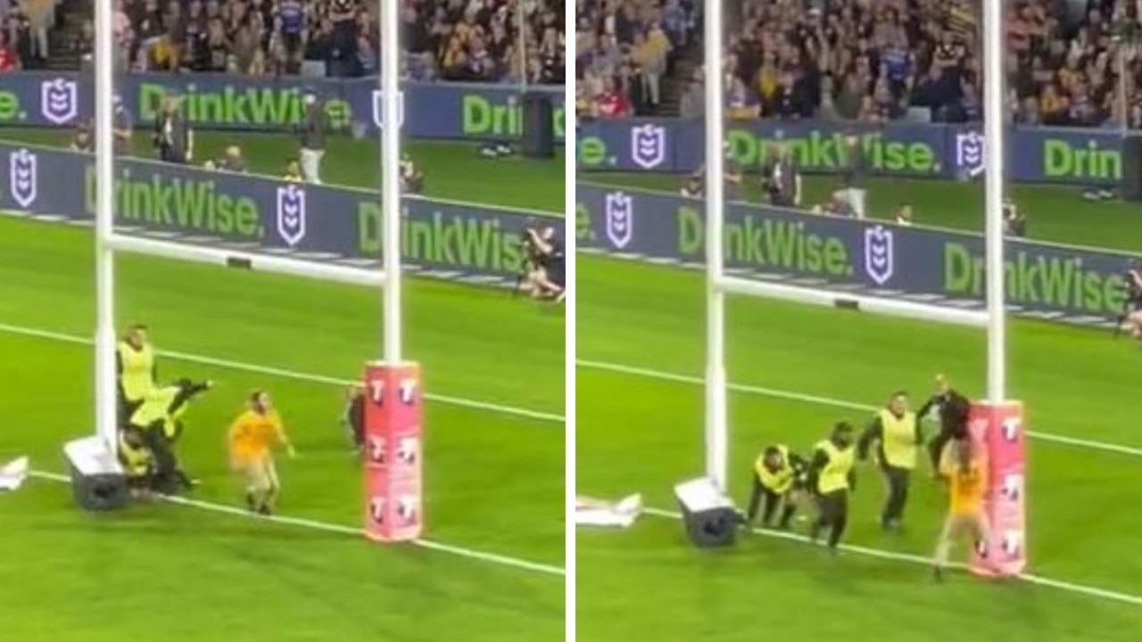 An intruder runs onto the field during the NRL Grand Final.