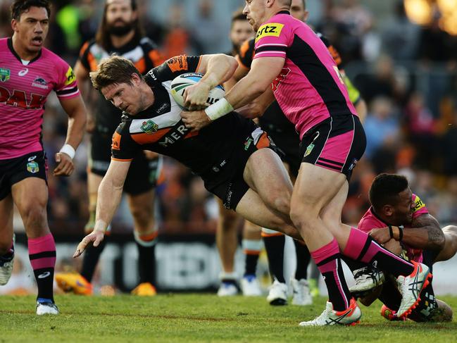 Tigers Chris Lawrence is tackled during the Wests Tigers v Penrith rugby league game at Leichhardt Oval, Sydney. Pic Brett Costello