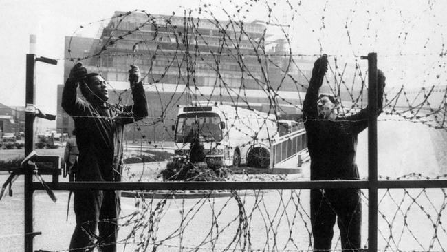 Barbed wire is removed from the entrance to the News International Plant at Wapping following the ending of the year long dispute. Picture: Press Association