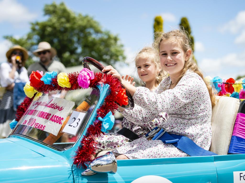 Driving in the Jacaranda Day grand parade in Goombungee is 10-year-old Chloe Brazier (behind the steering wheel) with her six-year-old sister Sophie, Saturday, November 5, 2022. Picture: Kevin Farmer