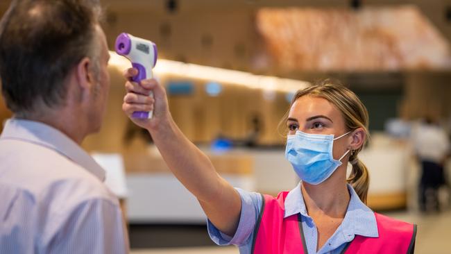 Registered Nurse Grace Heidke, 24, from Cromer taking the temperatures of everyone arriving at Northern Beaches Hospital in Frenchs Forest. Picture: Julian Andrews.