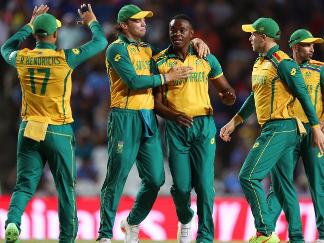 TAROUBA, TRINIDAD AND TOBAGO - JUNE 26: Kagiso Rabada of South Africa celebrates with teammates after bowling Mohammad Nabi of Afghanistan (not pictured) during the ICC Men's T20 Cricket World Cup West Indies & USA 2024 Semi-Final match between South Africa and Afghanistan at Brian Lara Cricket Academy on June 26, 2024 in Tarouba, Trinidad And Tobago. (Photo by Robert Cianflone/Getty Images)