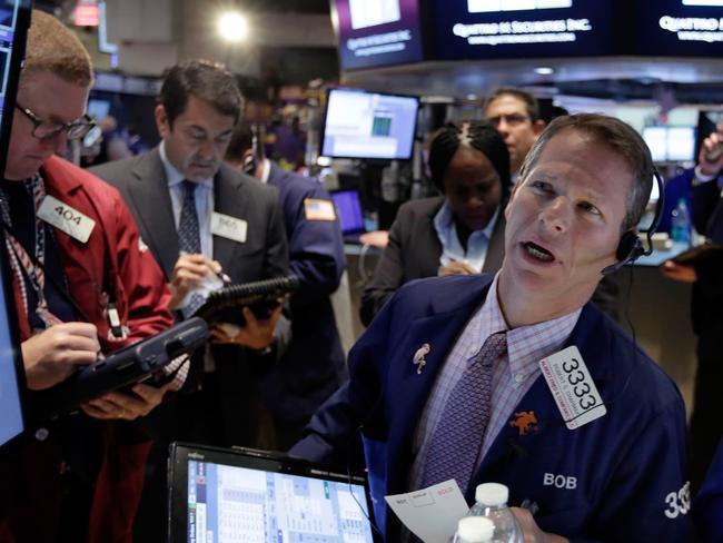 Robert Charmak, right, works with fellow traders on the floor of the New York Stock Exchange, Wednesday, June 10, 2015. U.S. stocks are opening higher, breaking a weeklong slump. (AP Photo/Richard Drew)