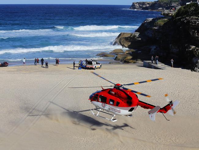 Paramedics try to save Richell at Tamarama beach on Wednesday. Picture: Brett Costello