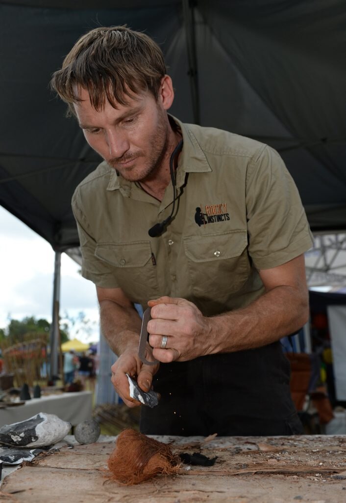 L-R Malachi Conway from Rocky Instincts demonstrates fire lighting with a flint and steel at the Cultural Festival held at the Heritage Village on Sunday. Photo: Chris Ison / The Morning Bulletin. Picture: Chris Ison