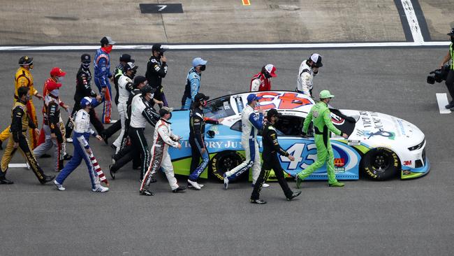 NASCAR walk alongside Bubba Wallace’s car in a sign of solidarity. Picture: Getty Images