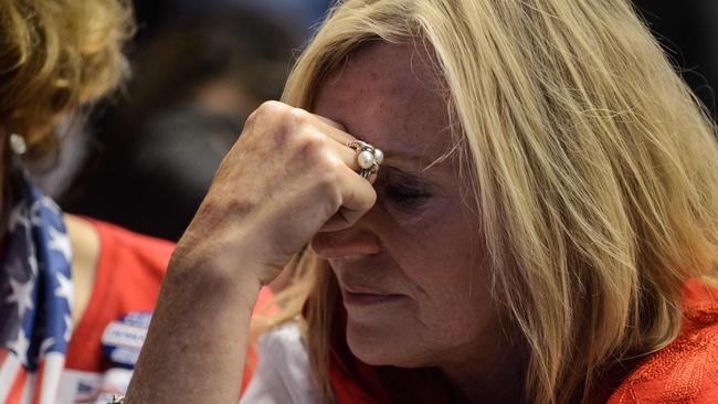 A supporter of Hillary Clinton reacts as to her loss as sharemarkets did the same. Picture: AFP