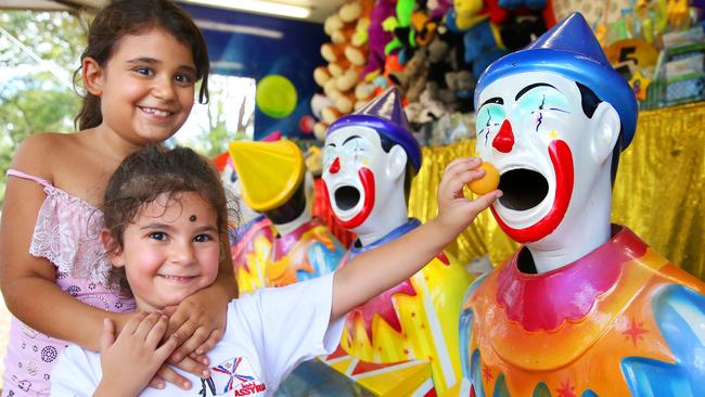 Sisters Jennifer, 8, and Simel Khoushaba, 4, feed the laughing clowns at the Assyrian, New Year Festival. Picture: Angelo Velardo