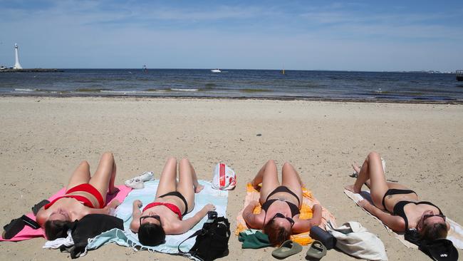 A group is seen soaking up the sun in Melbourne. Picture: NCA NewsWire / David Crosling