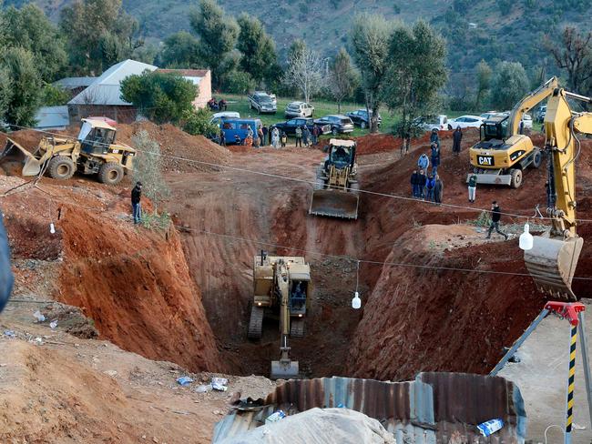 Moroccan authorities and firefighters work to get five-year-old child Rayan out of a well into which he fell after 48 hours earlier, on February 3, 2022 in the region of Chefchaouen near the city of Bab Berred. (Photo by AFP)