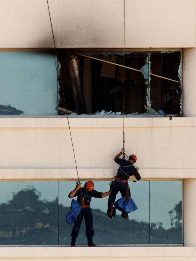 Police rescuers scale National Crime Authority building in Waymouth St after the explosion.