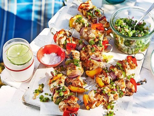 BBQ chicken skewers with green salsa.