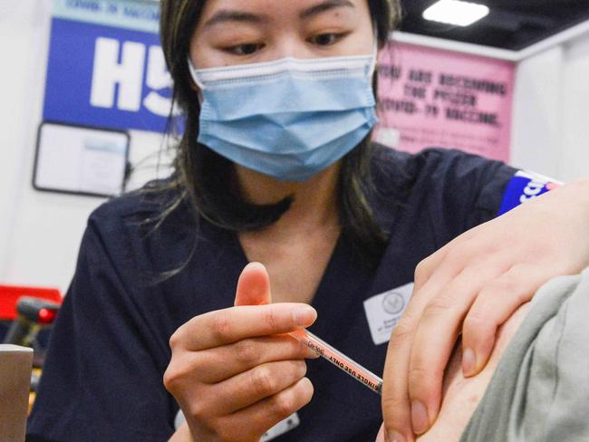 ADELAIDE, AUSTRALIA - NewsWire Photos NOVEMBER 4, 2021: SA Health vaccinator Xuan gives paramedic Sharon Hennessy a Covid booster vaccine at Wayville Vaccination Clinic. Picture: NCA NewsWire/Brenton Edwards