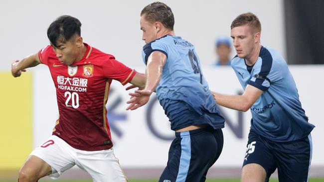 Sydney players battle for possession against Guangzhou Evergrande.