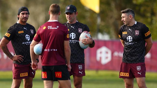 Queensland assistant coach Johnathan Thurston, left, is a key sounding board for Cameron Munster and halfback Daly Cherry-Evans. Picture: Chris Hyde/Getty Images