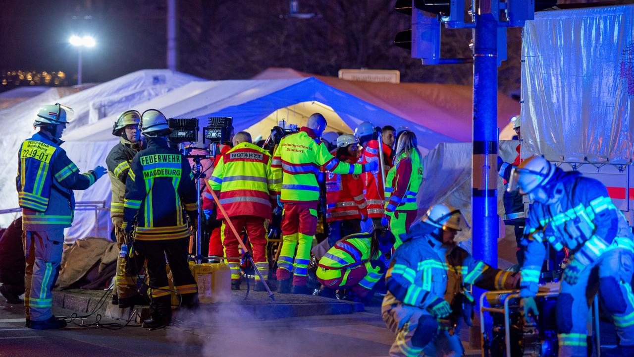 Police vans and ambulances stand next to the annual Christmas market in the city. Picture: Craig Stennett/Getty Images