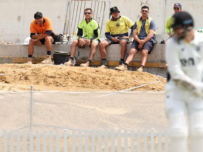 PERTH, AUSTRALIA - OCTOBER 08: Construction workers look on during their crib break on day one of the Sheffield Shield match between Western Australia and Queensland at the WACA Ground, on October 08, 2024, in Perth, Australia. (Photo by Paul Kane/Getty Images)