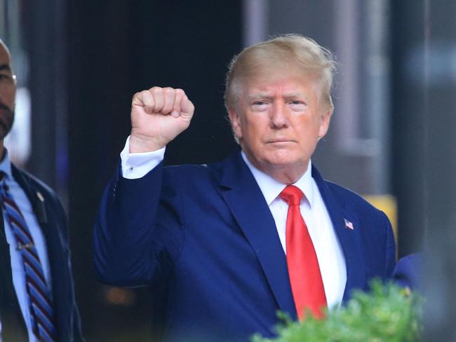 Former US President Donald Trump raises his fist while walking to a vehicle outside of Trump Tower in New York City. Picture: AFP