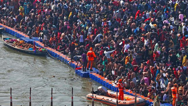 Hindu pilgrims gather to take a holy dip in the sacred waters of Sangam, the confluence of Ganges, Yamuna and mythical Saraswati rivers, during the Kumbh Mela festival in Prayagraj on Wednesday. Picture: AFP