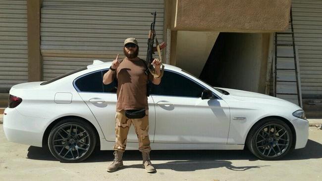 A picture showing Australian Khaled Sharrouf posing with an AK-47 in front of a sports car from an undisclosed location within Iraq. CREDIT: TWITTER