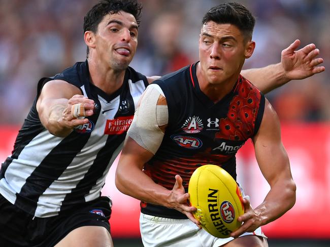 MELBOURNE, AUSTRALIA - APRIL 25: Jye Caldwell of the Bombers is tackled by Scott Pendlebury of the Magpies during the round six AFL match between Collingwood Magpies and Essendon Bombers at Melbourne Cricket Ground, on April 25, 2023, in Melbourne, Australia. (Photo by Quinn Rooney/Getty Images)