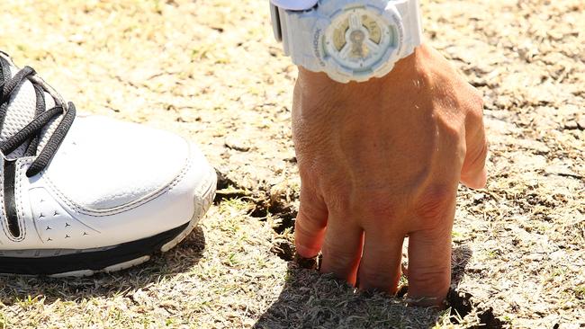 PERTH, AUSTRALIA - NOVEMBER 07: An umpire inspects cracks in the pitch before start of play during day five of the First Test match between Australia and South Africa at the WACA on November 7, 2016 in Perth, Australia.  (Photo by Paul Kane/Getty Images)