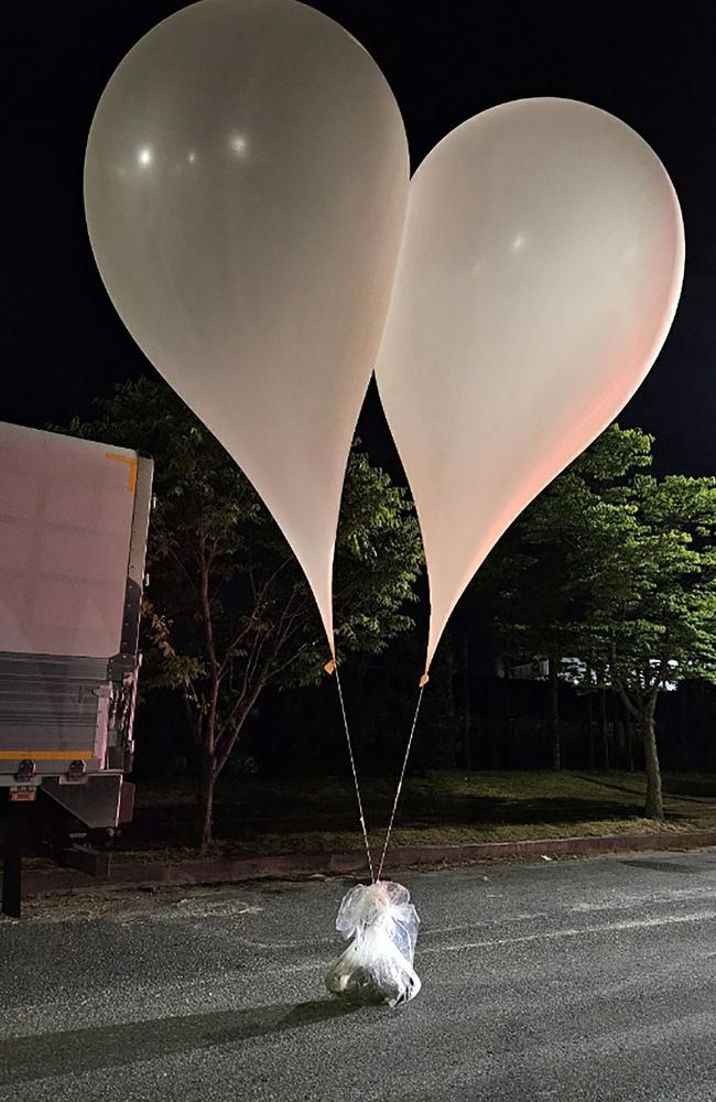 Unidentified objects believed to be excrement and North Korean propaganda material attached to balloons on a street in Chungnam Province. (Photo by Handout / South Korean Defence Ministry / AFP)