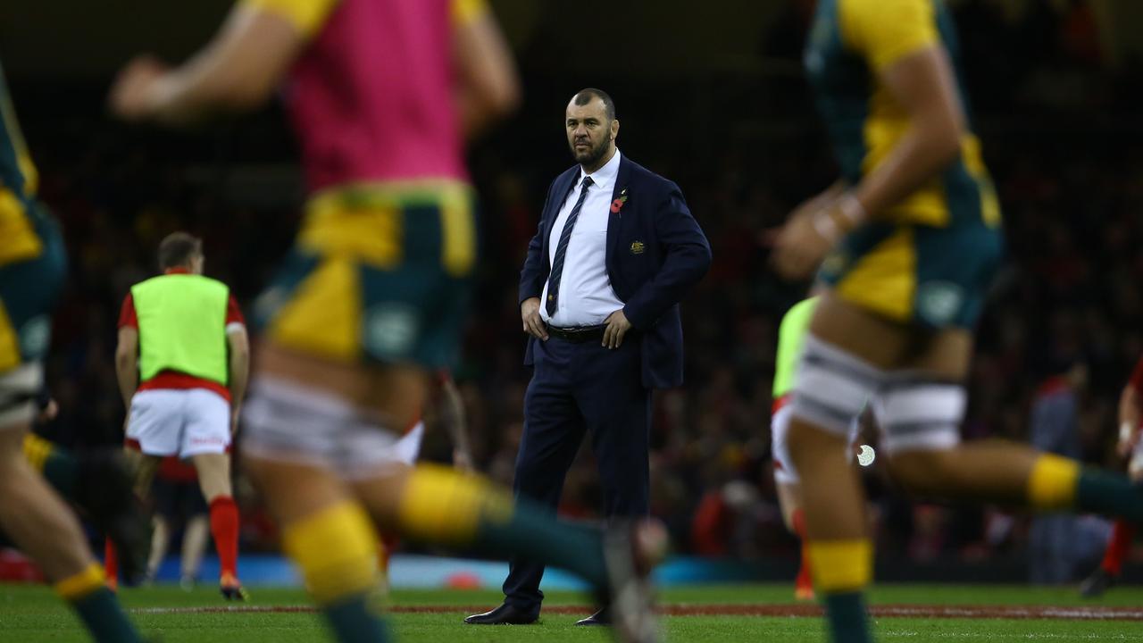 Australia coach Michael Cheika watches his players warm up in Cardiff.