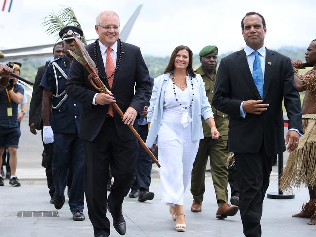 Australian Prime Minister Scott Morrison and Mrs Morrison are greeted by Vanuatu Minister of Foreign Affairs Ralph Regenvanu (right) as they arrive in Port Vila, Vanuatu, Wednesday, January 16, 2019. The prime minister will discuss Australian infrastructure investment, the Pacific labour hire scheme, and building cultural, economic and social ties between the two countries. (AAP Image/Dan Himbrechts) NO ARCHIVING