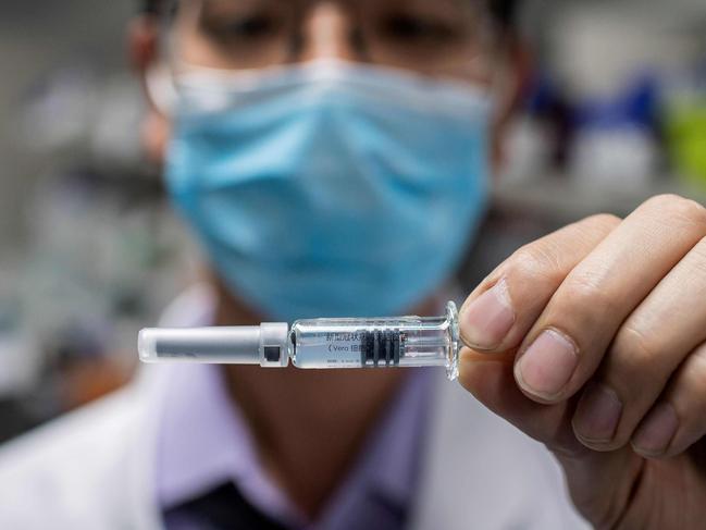 (FILES) This file photo taken on April 29, 2020 shows an engineer showing an experimental vaccine for the Covid-19 coronavirus that was tested at the Quality Control Laboratory at the Sinovac Biotech facilities in Beijing. (Photo by Nicolas ASFOURI / AFP) / TO GO WITH STORY virus-Ã©pidÃ©mie-santÃ©-vaccins-Chine by Ludovic Ehret