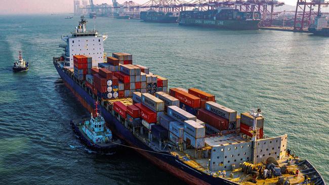 A cargo ship loaded with containers makes its way at a port in Qingdao in China's eastern Shandong province. Picture: STR/ AFP.