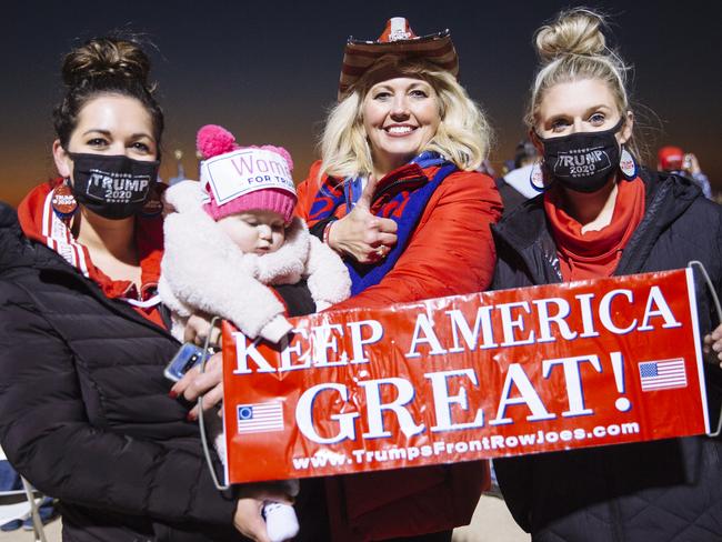 Marandamae Pacheco, 26, Makinley Mae Pacheco, 6 months, Marthamae Kottschade, 51, and Alishia Brennan, 27, at a rally for President Donald Trump at Rochester International Airport in Rochester, Minnesota. Picture: Angus Mordant