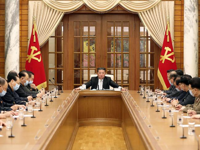 TOPSHOT - This picture taken and released from North Korea's official Korean Central News Agency (KCNA) on May 12, 2022 shows North Korean leader Kim Jong Un (C) attending the 8th political bureau meeting of the Workers Party of Korea (WPK)in Pyongyang. (Photo by various sources / AFP) / South Korea OUT / ---EDITORS NOTE--- RESTRICTED TO EDITORIAL USE - MANDATORY CREDIT "AFP PHOTO/KCNA VIA KNS" - NO MARKETING NO ADVERTISING CAMPAIGNS - DISTRIBUTED AS A SERVICE TO CLIENTS / THIS PICTURE WAS MADE AVAILABLE BY A THIRD PARTY. AFP CAN NOT INDEPENDENTLY VERIFY THE AUTHENTICITY, LOCATION, DATE AND CONTENT OF THIS IMAGE --- /