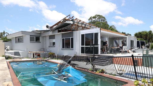 Residents survey the damage at Helensvale caused by wild weather Christmas night. The home of Trish and Bob Avery had its roof ripped off during the storm.. Picture Glenn Hampson