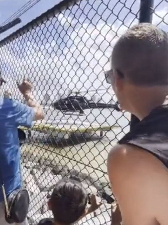 Neil de Silva (far left) waves to his wife Winnie de Silva and step son Leon as they take off in the Sea World helicopter which would crash shortly after. Picture: Supplied