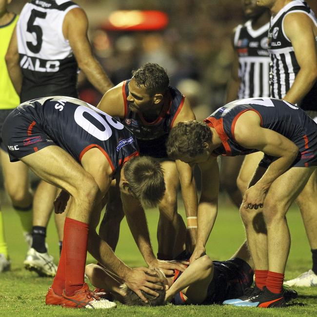 One of the few times the Redlegs were feeling pain. Cody Szust lies on the ground after taking a heavy knock. Picture: Dean Martin