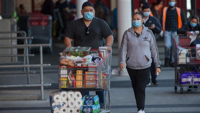 Shoppers poured out of Costco with faces covered and trollies full. Picture: Paul Jeffers