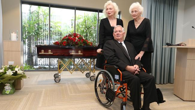 The O'Connell family, wife Lorraine, and siblings Suzanne and Greg, grieving over the coffin of Denis O'Connell. Picture Glenn Hampson